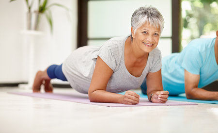 Senior woman, plank and exercise in home, portrait and plank training in retirement. Elderly people, happy person and class for pilates fitness or wellness, strong and confident start to challengeの写真素材