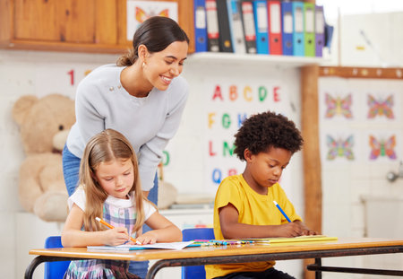 Teacher, education and students in classroom, studying and knowledge with help. Educator, woman and kids at school, lesson and answer with questions, child development and learning with testの写真素材