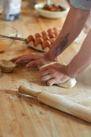 Person, hands and kneading with dough for baking, pastry or dessert with flour, eggs or new recipe...