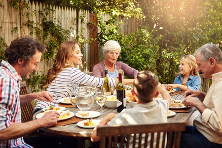 Lunch, celebration and family with reunion, smile and together in home backyard. Grandparents, woman...