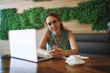 Woman, smile and laptop in cafe with remote work, pride or happy for media job in portrait. Person,...