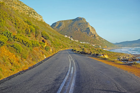 Nature, sea and road with highway for adventure, destination and outdoor location for holiday journey. Driveway, sustainable and ecology with mountain for plants, travel and landscape in Switzerlandの写真素材