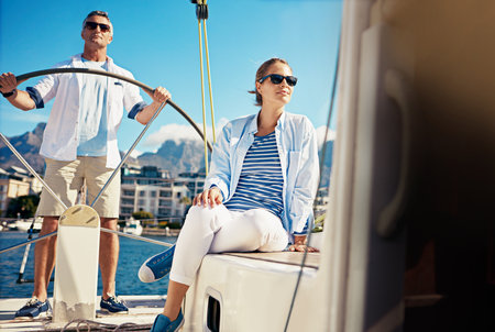 Ocean, travel or couple on yacht for view, vacation or holiday with love, ideas or adventure in Greece. Cruise, mature or people on boat at sea to relax for tropical honeymoon trip or anniversaryの写真素材