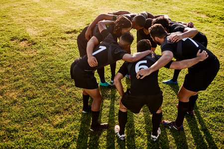 Rugby, team and huddle together for exercise, motivation and game field for match preparation. Above sports, fitness and group of men outdoor with competition planning, club and practice with talkの写真素材