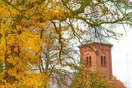 Autumn, background and steeple of church outdoor for belief in God, Christian faith or religion. Architecture, building and temple in nature for spirituality or worship of divine deity or Jesusの写真素材