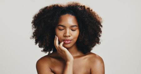 Glow, skincare and beauty with face of woman in studio for spa treatment, self care and cosmetics. Aesthetic, collagen and dermatology with African person on white background for shine and salonの写真素材