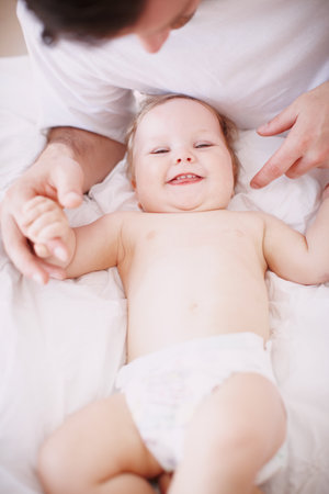 Home, bed and father with baby in portrait, bonding together and child development with growth. House, family and dad with infant kid for playful, support and relationship with laughing from aboveの写真素材