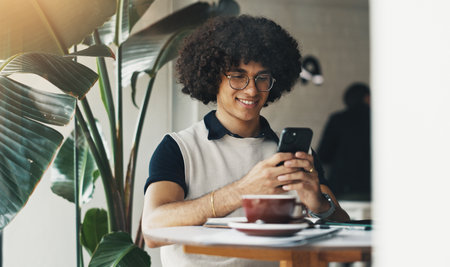 Happy, entrepreneur or man in cafe with phone for small business review, ratings or hospitality survey. Restaurant menu, smile and customer with mobile for break, coffee shop discount or feedbackの写真素材