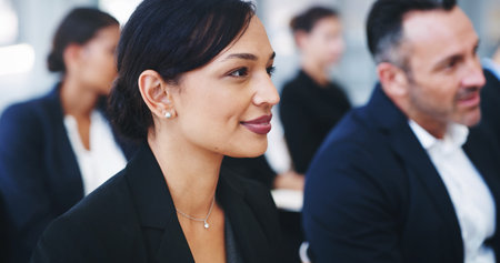 Business woman, smile and listening in audience for budget speech, finance and seminar for growth in economy. Person, happy and crowd at conference, attention and auditorium for corporate conventionの写真素材