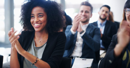 Professional woman, group and applause at conference for corporate event, smile with support and praise. Audience, team and business people clapping for seminar success, congratulations or cheersの写真素材