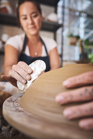 People, hands and pottery class for molding, working together and carving clay for ceramic crafts. Teaching, equipment and helping with lesson at workshop, practice technique and support with toolの写真素材