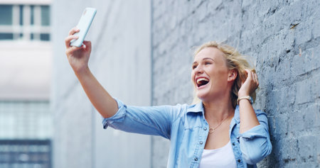 Selfie, happy and woman in city laugh with smile for social media, online post and profile picture. Excited, influencer and person take photo for memories on holiday, vacation and weekend in townの写真素材