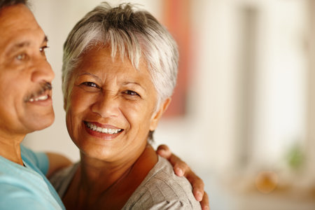 Old woman, senior or happy couple hug in house for support, retirement or anniversary together. Smile, healthy marriage or elderly people with love, embrace or care for bonding, comfort or romanceの写真素材