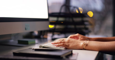 Hands, person and typing on computer in office for administration, research and email feedback. Woman, keyboard and online for communication, schedule update and business report with proposal notesの写真素材