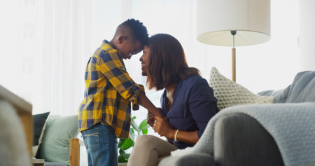 Smile, mother and touch forehead with kid in home for care, love and family bonding together....