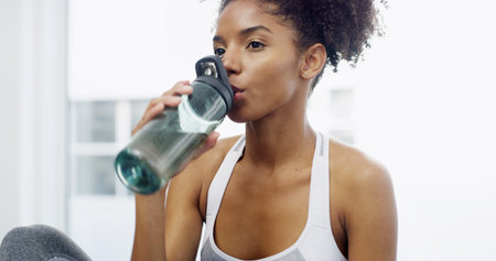 Active, woman and drink water at house for hydration, exercise break and diet nutrition of wellness....