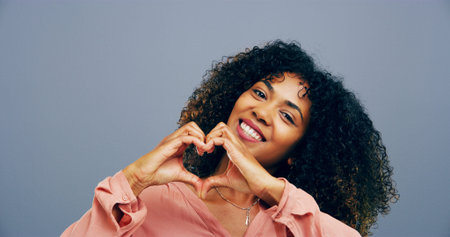 Hands in heart, studio and portrait of black woman with gesture for support, kindness and care....