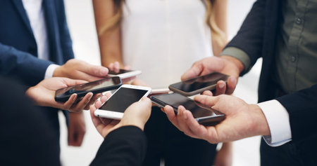 Hands, business people and phone in circle at office for networking, data sync and mockup space for...