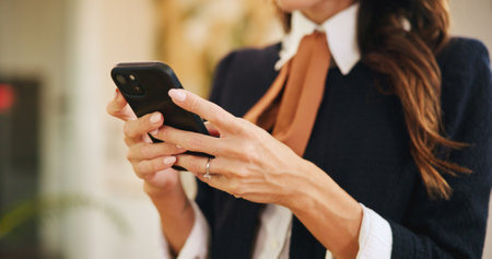 Hands, business woman and phone in hotel for online booking, reservation schedule or information update. Mobile, worker and communication closeup on internet with concierge typing on hospitality appの写真素材