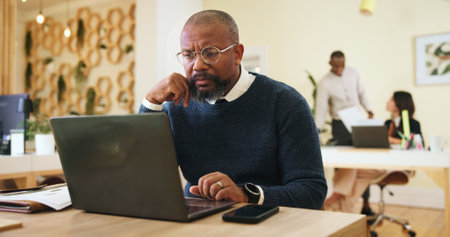 Research, glasses and laptop with business man in office for event planner, reading and client feedback. Online, project management and startup with person in creative agency for email and ideaの写真素材