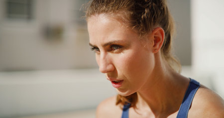 Breathing, outdoor and woman with fitness, tired and calm with rest, wellness or challenge. Healthy person, athlete or girl in street, training or workout with runner, fatigue or exhausted with spaceの写真素材