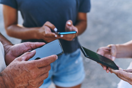 Closeup, people and hands with screen for smartphone, connectivity and online for communication. Outdoor, share network and friends with mobile for application, download software and social mediaの写真素材