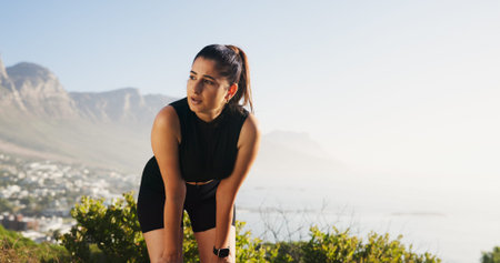 Calm, woman or breathing with fitness in nature for break, rest or recovery on mountain. Tired,...