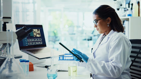 Scientist, woman and tablet with report for chemistry, testing and medical research. Biotech, laboratory and analysis with data inspection for pharmaceutical or pathology experiment for breakthroughの写真素材