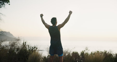 Freedom, fitness and back of man in nature for mockup space, success and health. Runner, workout and winner with person and training with mountain view for sports athlete, achievement and exerciseの写真素材