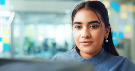 Office, businesswoman and reading with laptop for research, article and publication for news story. Career, female person and journalist from creative agency with digital, editing or website for blogの写真素材