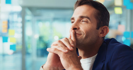 Creative, solution and man with thinking in office for campaign inspiration, problem solving and ideas. Design agency, space and business person with smile for project management, planning and visionの写真素材