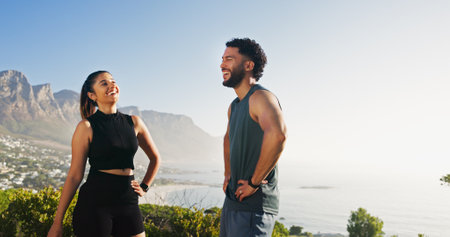 Couple, nature and rest for break in training, fitness and recovery with laugh or joy as athlete. People, outdoor and hike for marathon, sports and workout for bonding together for health or wellnessの写真素材