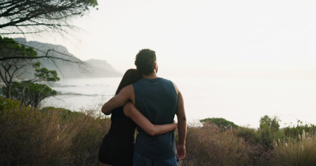 Fitness, couple and hug with outdoor view of ocean, mockup space and training break by mountain. Exercise, man and embrace woman in nature to rest for body health, love and back together for wellnessの写真素材