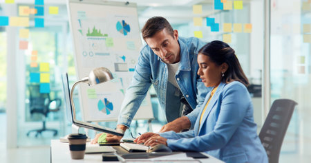 Business people, laptop and typing in office, conversation and feedback with email for funding application. Employees, coworking and consultant for sales agency, pc and internet with website infoの写真素材