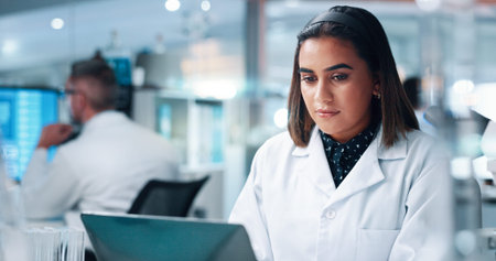 Research, scientist and woman with laptop, medical experiment and internet with healthcare. Person,...