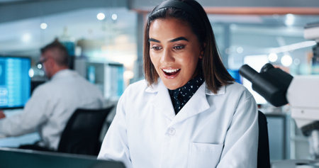 Surprise, scientist and woman in laboratory for research breakthrough, healthcare innovation or success. Science professional, wow and shock for medical discovery, winning award and happy with laptopの写真素材
