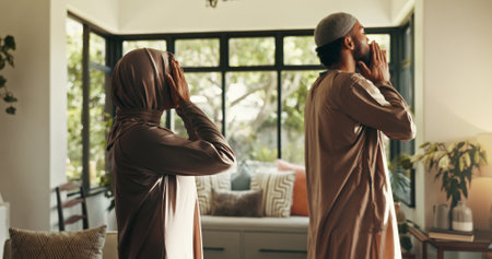 Muslim, couple and Islamic prayer with belief for spiritual worship, religion faith and praise to Allah. People, dua and reflection for Eid Mubarak, holy devotion and gratitude for commitment at homeの写真素材