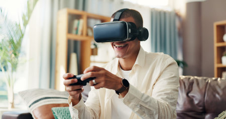 Man, vr goggles and video game on sofa, controller and happy in home for challenge in 3D metaverse. Person, augmented reality and glasses with futuristic ux, play and smile with click at apartmentの写真素材