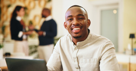 Laptop, portrait and smile of business black man in office for publishing with editor. Computer, happy and journalism with creative employee in workplace for online magazine article or reportの写真素材
