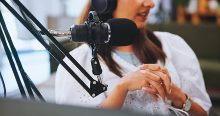 Hands, woman and mic for podcast, talk show and conversation with broadcast, radio or closeup. Person, host or influencer with equipment for live streaming, tech for political news channel or explainの写真素材