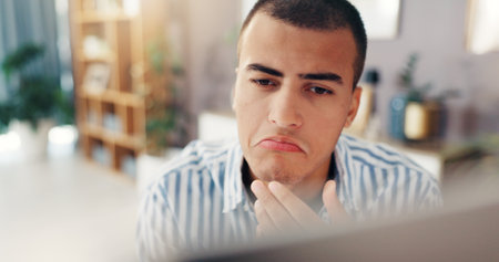 Man, thinking and remote work with computer for decision, choice or planning creative solution. Face, male person or thoughtful freelancer with technology for software update or schedule at homeの写真素材