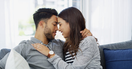 Relax, love and forehead with couple on sofa of home for bonding, support and hug. Happiness,...