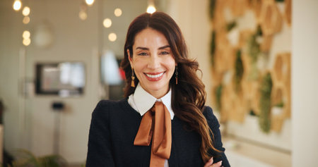 Portrait, business and woman with confidence in office for about us, event planning and curator. Female person, artist and arms crossed at art gallery, collection and artwork exhibit for opportunityの写真素材