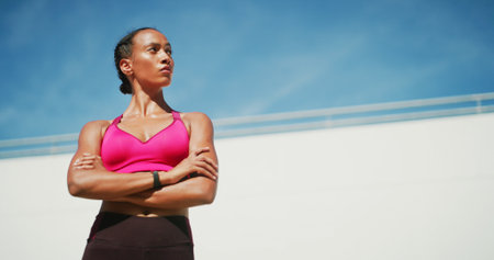 Fitness, woman and arms crossed with thinking, exercise space and sweat with wellness. Athlete, confidence and blue sky mockup for performance, body goals and outdoors for summer sports and balanceの写真素材