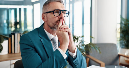 Mature businessman, thinking and stress in office, reflection and solution at investment agency. Person, financial advisor and problem solving with perspective, choice or decision for stock marketの写真素材