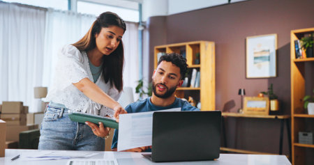 Business people, documents and laptop in workspace, boxes and planning with inventory. Employees, startup company or coworking with pc, report for profit growth and review for taxes, talk or feedbackの写真素材