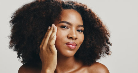 Foundation, skincare and portrait of African woman in studio for makeup, cosmetics and facial treatment. Dermatology, face or model with beauty for health, glow or natural shine on white backgroundの写真素材
