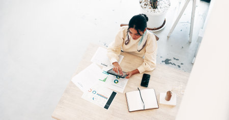 Above, business and woman on tablet in office of research, financial report and schedule update. Accountant, digital and documents of finance growth, revenue information and investment infographicsの写真素材