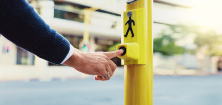 Person, hands and pedestrian with button for crosswalk, road safety or security in city. Closeup,...