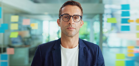 Portrait, creative and business man with glasses in office or serious journalist in startup. Face,...
